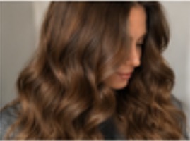 Rich brunette with a precision cut and soft waves