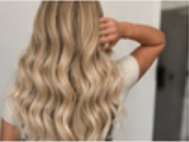 Long blonde hand-tied extensions with soft waves